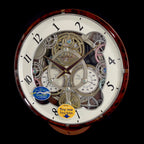 Rhythm “Widget (Woodgrain)” Skeletonized Dial Magic Motion Musical Wall Clock with Moving Gears - 4MH886WU23