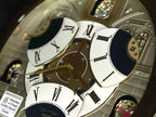 Seiko QXM371BRH “Castle Windows” Melodies in Motion Dancing Dial Musical Wall Clock with 19 Songs